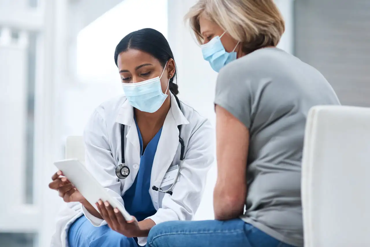 Doctor and patient look over a file together